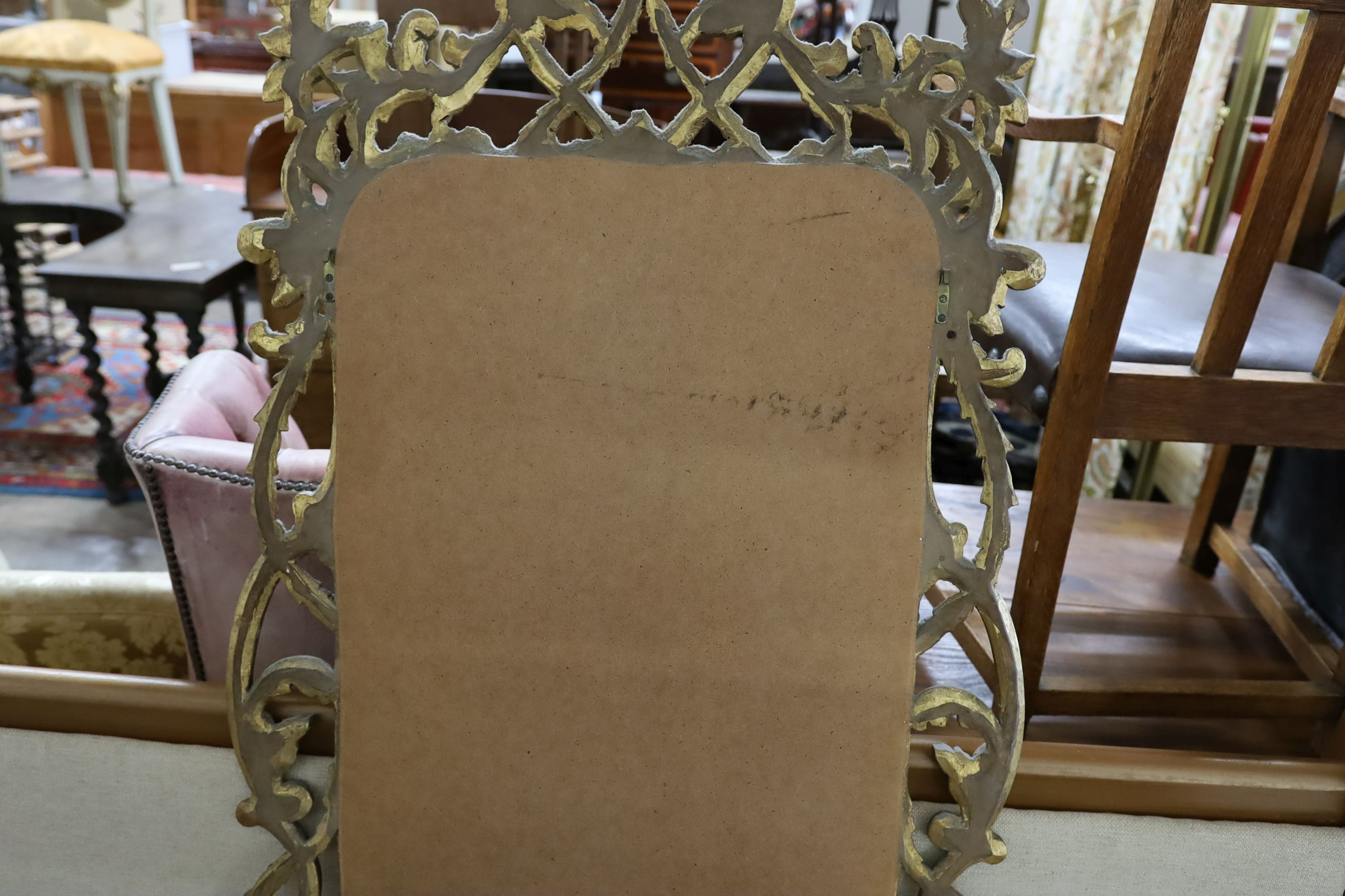 An 18th century style carved giltwood scrollwork mirror, width 64cm, height 132cm